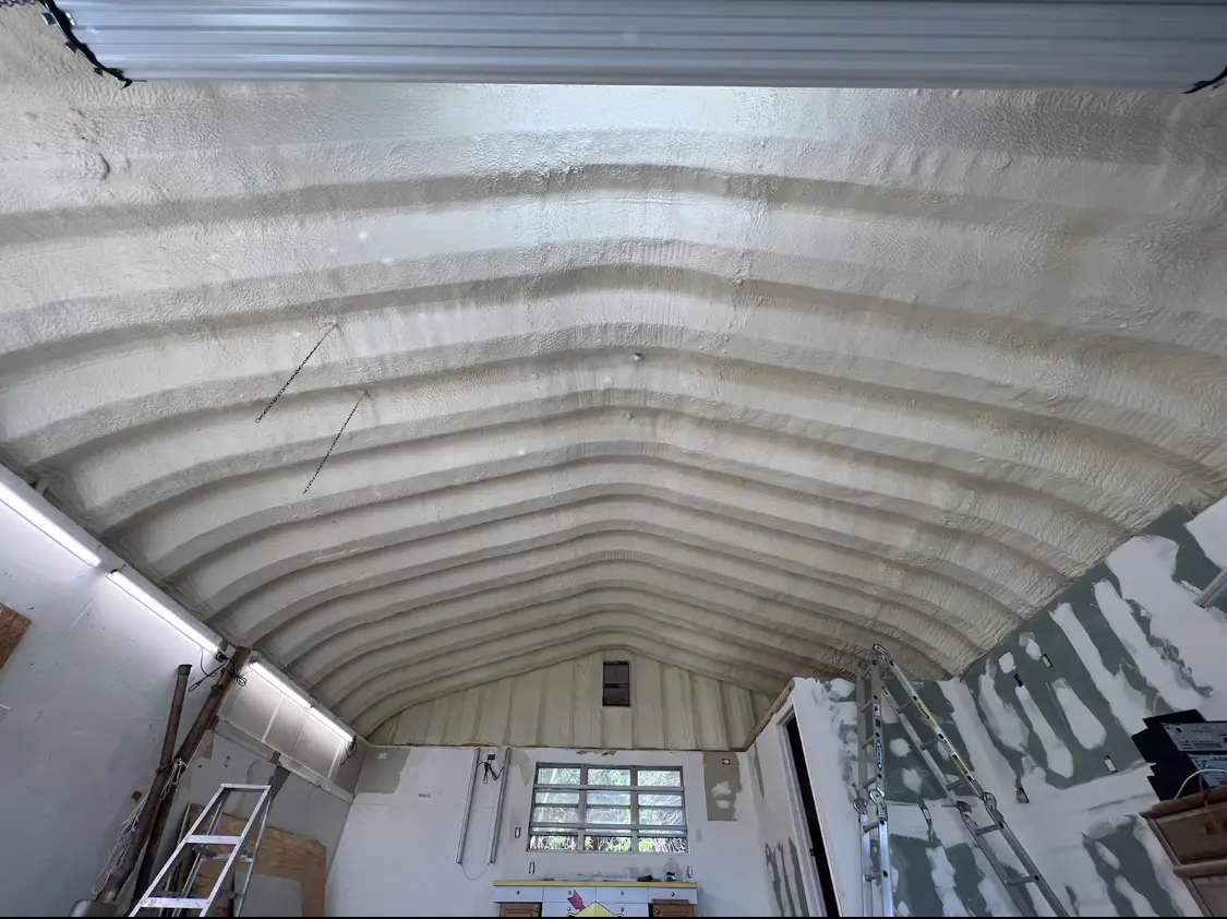 Spray polyurethane foam applied to the underside of a metal roof deck in Woodbury